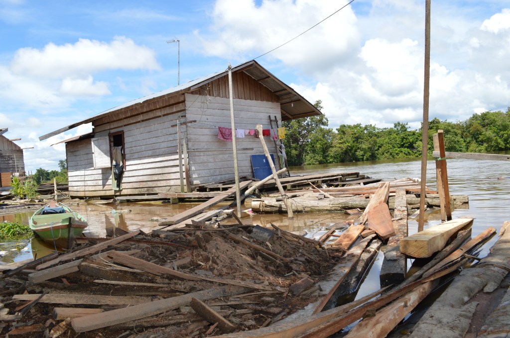 Houses are scattered around the mill and lumber piles