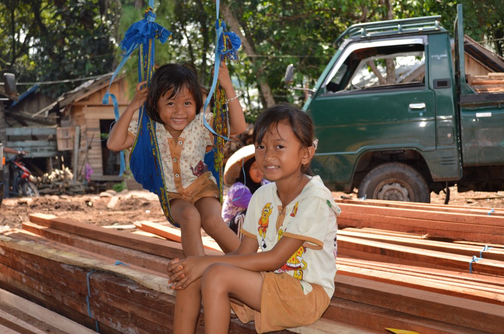 Children play among the lumber